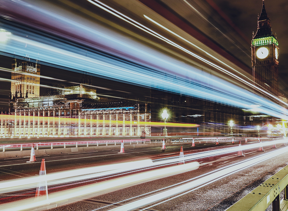 Photo of London at night, with Big Ben clock tower towering over the city. Photo by Arthur Yao on Unsplash.