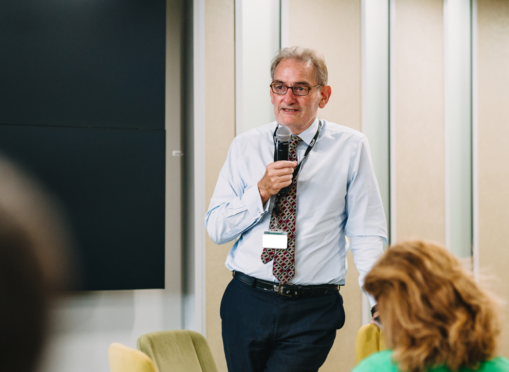 Photo of national statistician Professor Sir Ian Diamond, standing, with microphone, during a talk.